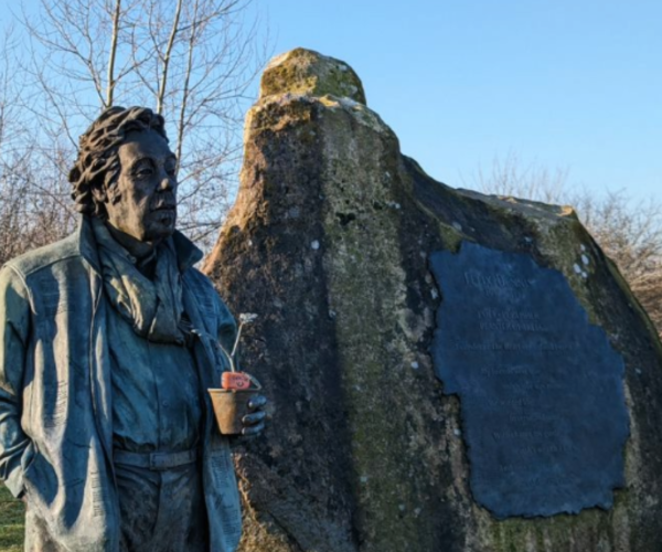 A close-up of Felix Dennis' statue and rock