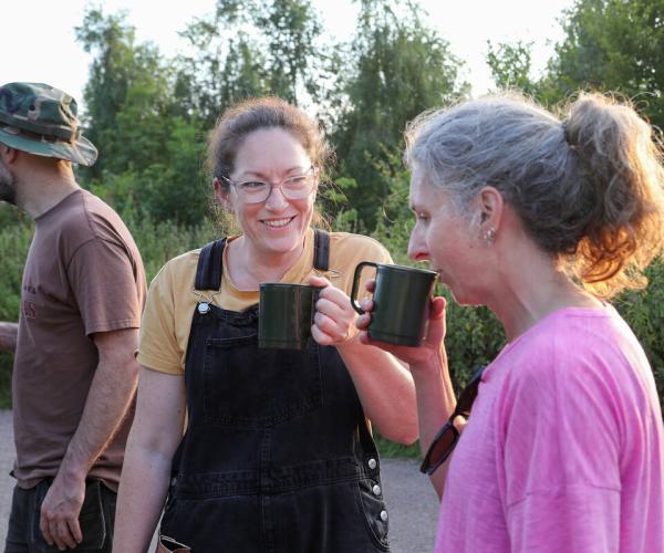 Two volunteers having a chat and a cup of tea