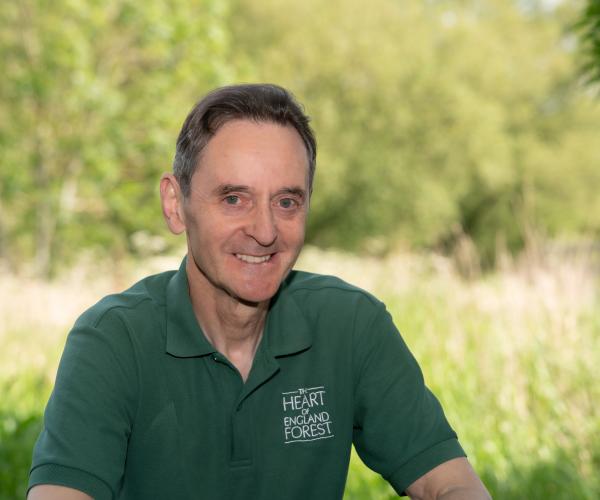 A photo of Paul Hirons leaning on a gate smiling