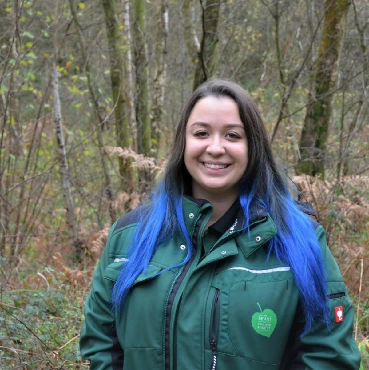 Biodiversity Officer Tasha stood in the Forest smiling at the camera 