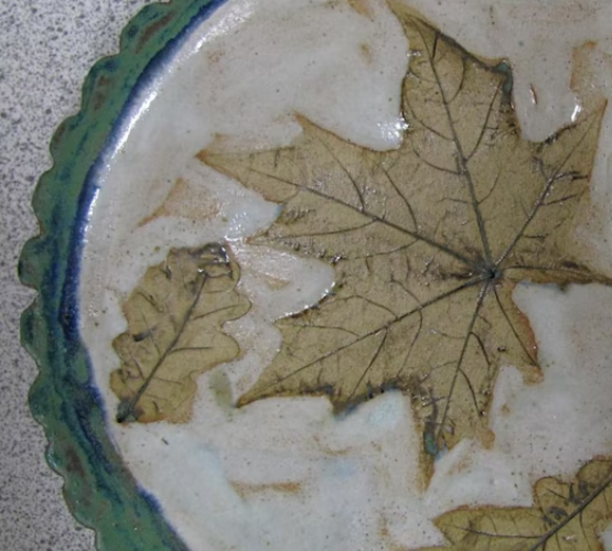 close up of ceramic dish with leave print 