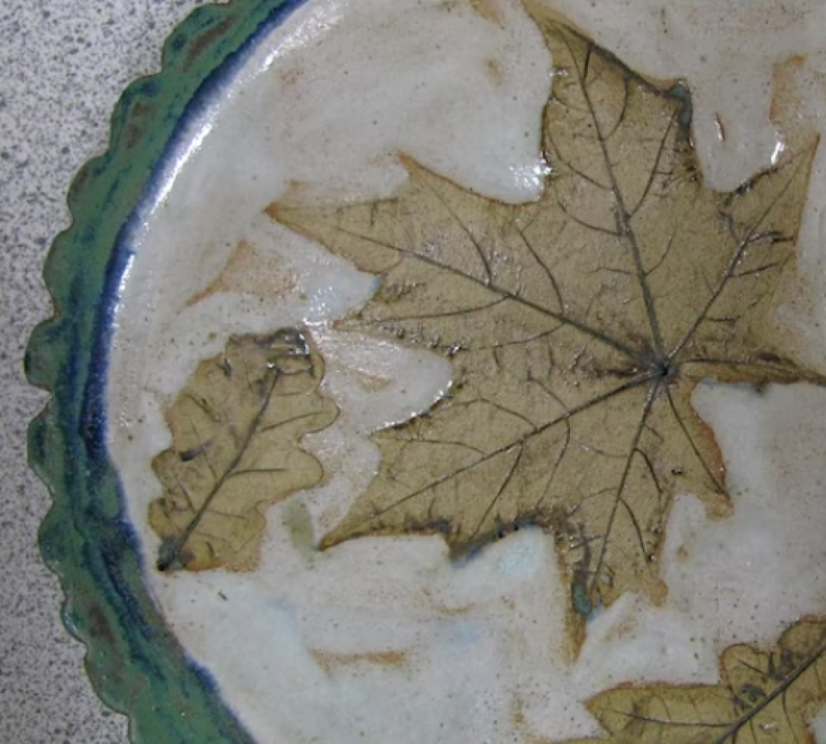 close up of ceramic dish with leave print