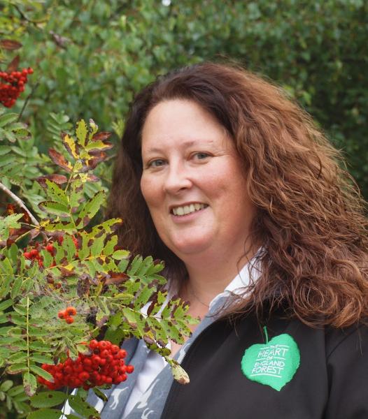 Close up of Beth Brook stood by a tree