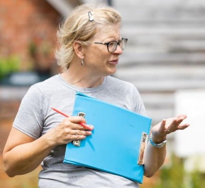 Andrea stood outside with a clipboard talking