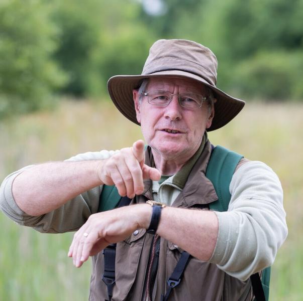 Alan stood in the Forest leading a dragonfly session