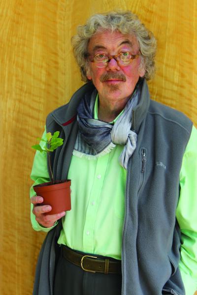 Felix Dennis holding a young oak sapling