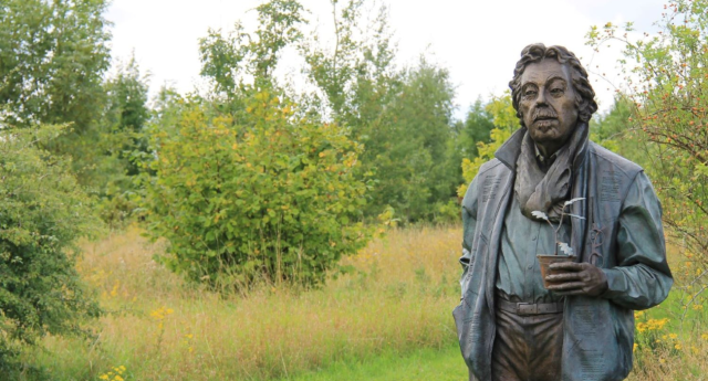 The statue of Felix Dennis along the Founder's Walk