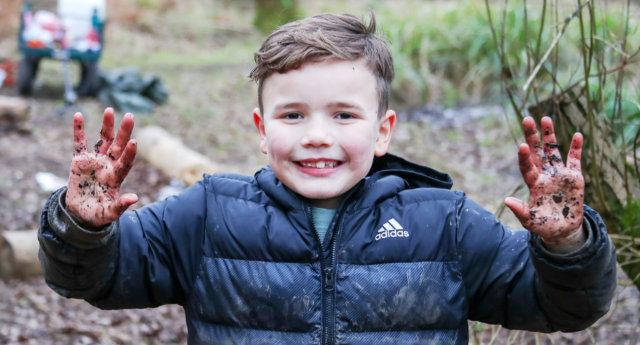 A child showing off his muddy hands at Middle Spernal