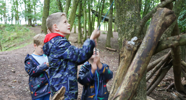 A group of children building a den at Middle Spernal