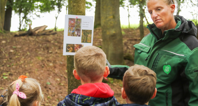 A couple of children doing outdoor activities with a member of staff at Middle Spernal