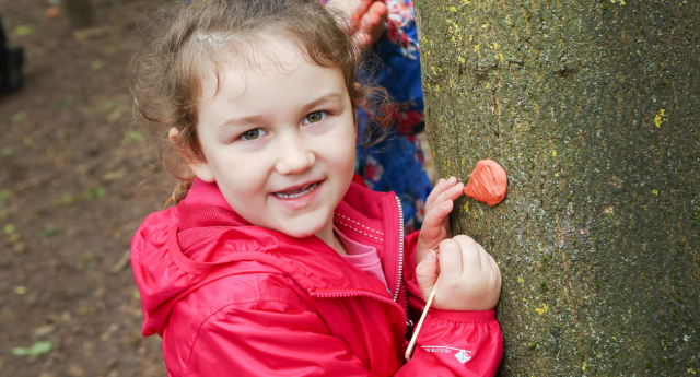 A child being creative in the woodland at Middle Spernal