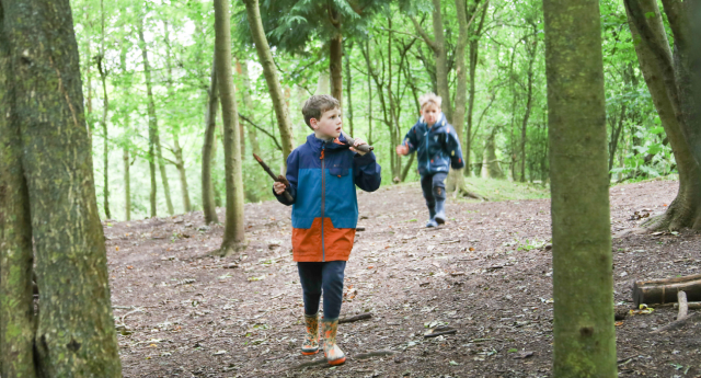 A couple of children being walking through the woodland at Middle Spernal