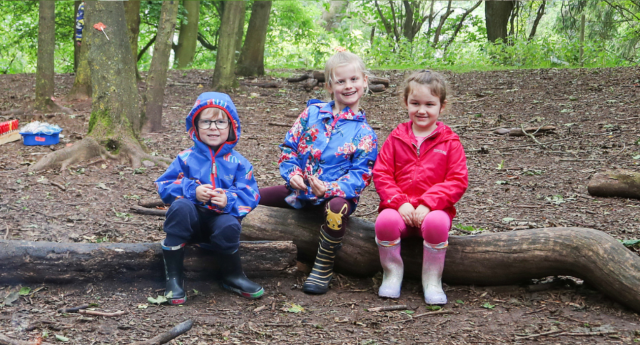 A group of children sitting on a log at Middle Spernal