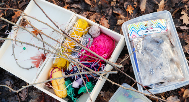 Trays of arts and crafts materials on the forest floor at Gorcott Hill