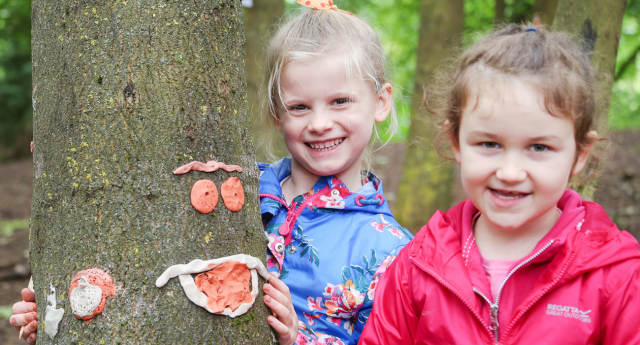 A couple of young children having fun being creative in the Forest