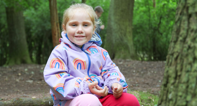 A child having fun in the woodland at Gorcott Hill