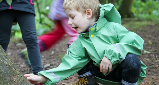 A child having fun in the woodland at Gorcott Hill