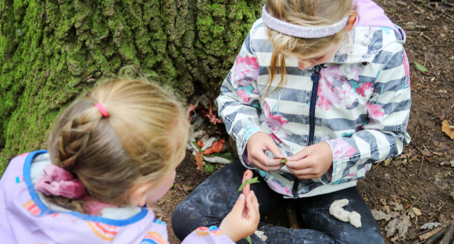 A couple of children having fun in the woodland at Gorcott Hill