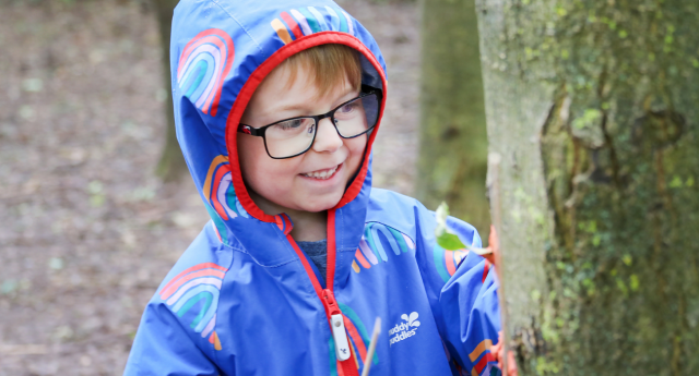 A child having fun in the woodland at Gorcott Hill