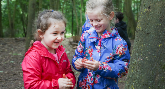 A couple of children having fun in the woodland at Gorcott Hill