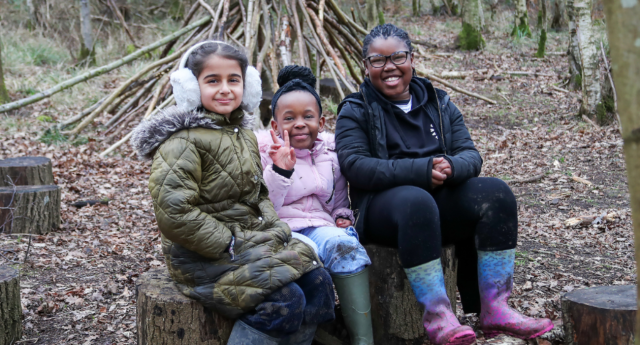 A group of Young Foresters sitting on logs together Gorcott Hill