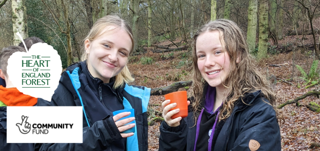 Young people enjoying a hot drink during a woodland activity at the Heart of England Forest.