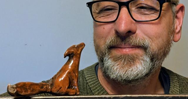 Pottery Throw Down finalist David Short looking at a small fox figurine